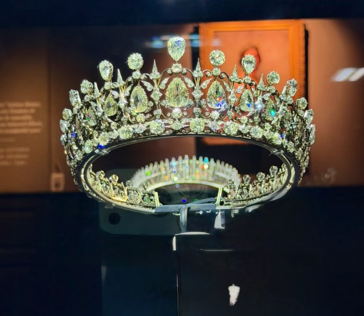 A diamond circlet lit in its case in the Jewel Room, graduated pear-cut stones set in scrollwork above a band of smaller brilliants