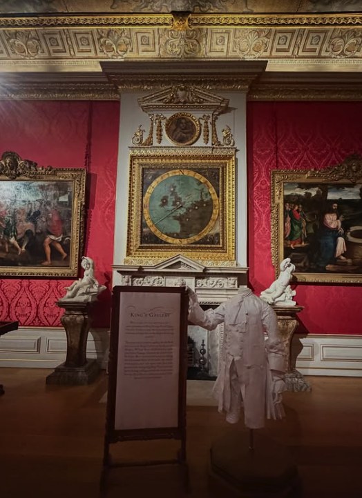 The 1694 wind dial above the King's Gallery chimneypiece at Kensington Palace, its painted map of north-western Europe set in a gilded frame under a broken pediment